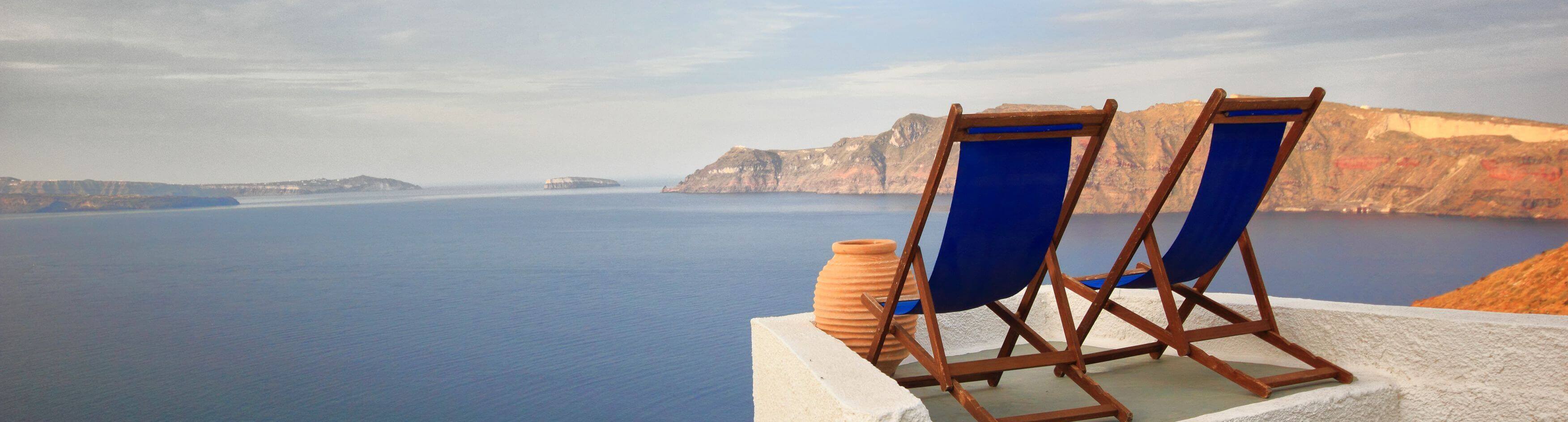 Sunbeds on Santorini's roofs at sunrise